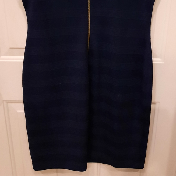 Navy blue dress, there's a pull in the material that can be tucked into fabric. - Picture 4 of 5